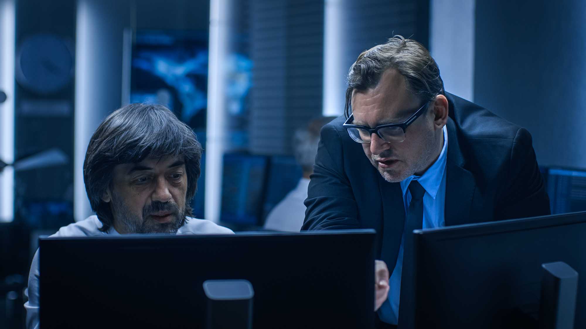 Government Chief of Cyber Security Consults Operations Officer who Works on Computer. Specialists Working on Computers in System Control Room.